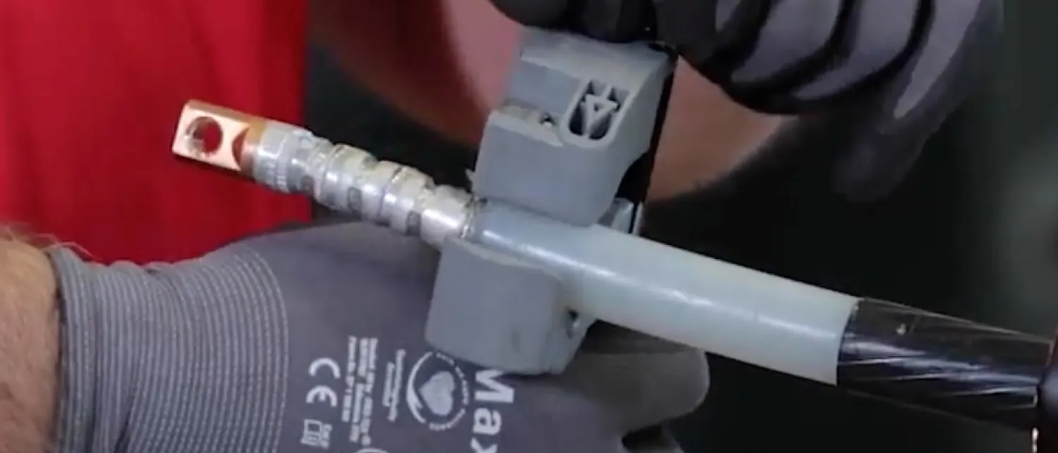 Technician chamfers insulation of the cable