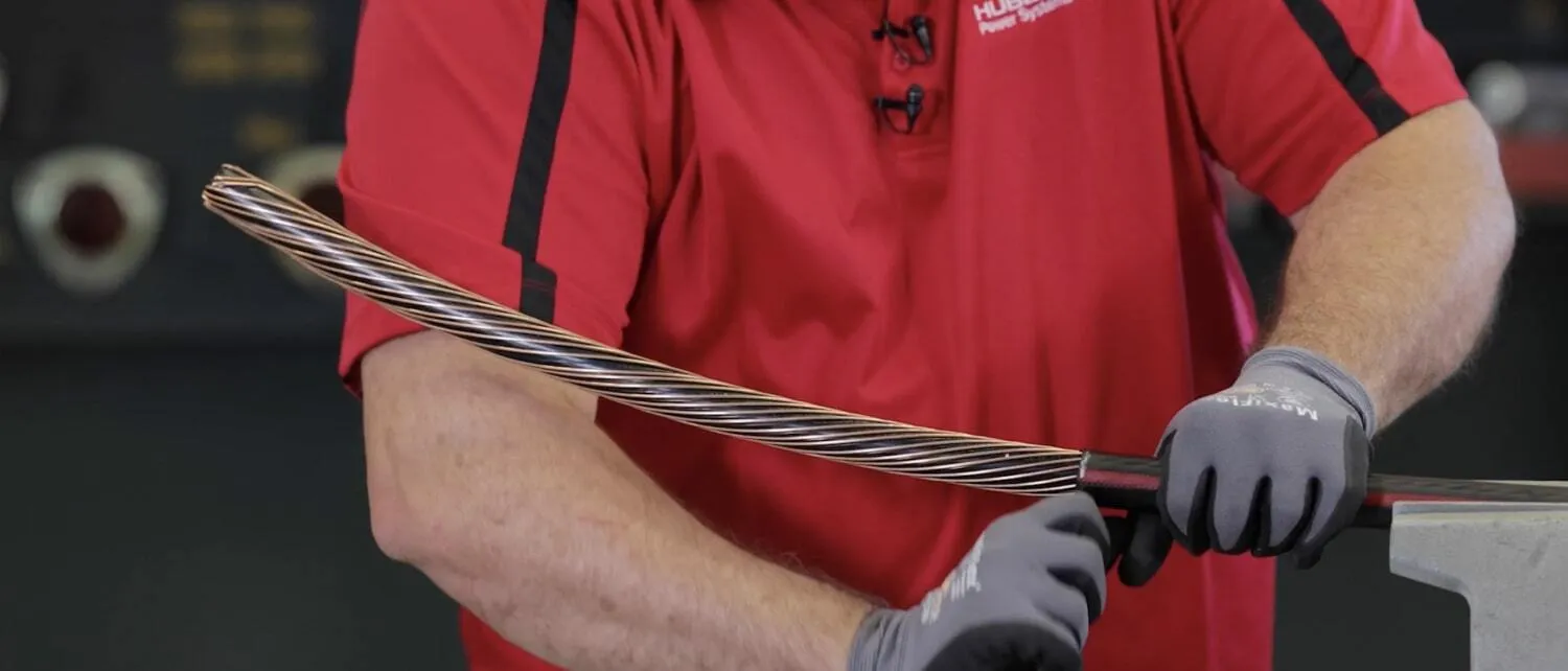Technician removes scored jacket from cable