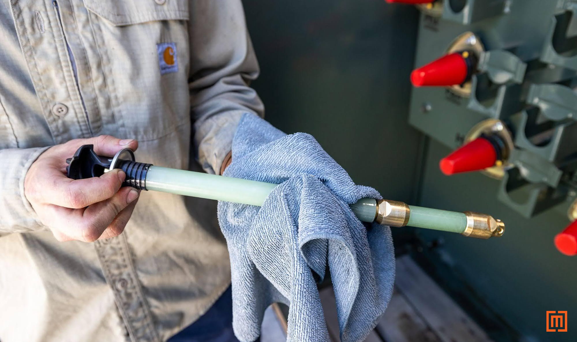 photo of tech wiping extracted bayonet fuse clean