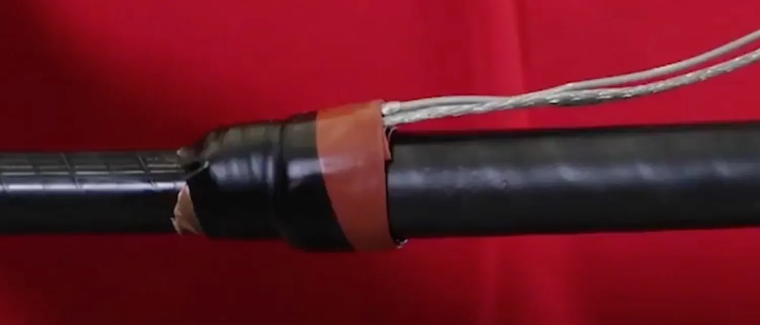 Mastic and electrical tape cover the shield adapter kit to the cable