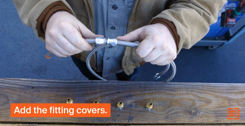 Mechanic adding fitting covers to transformer hose