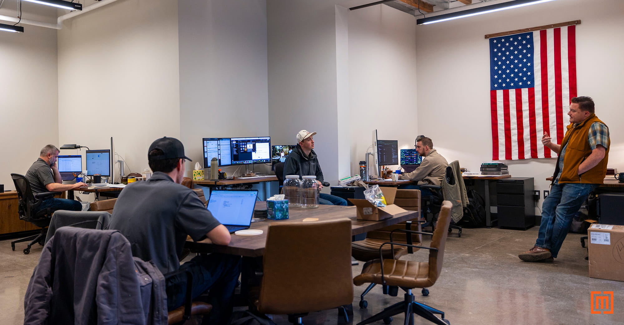 Maddox employees in new office with American flag