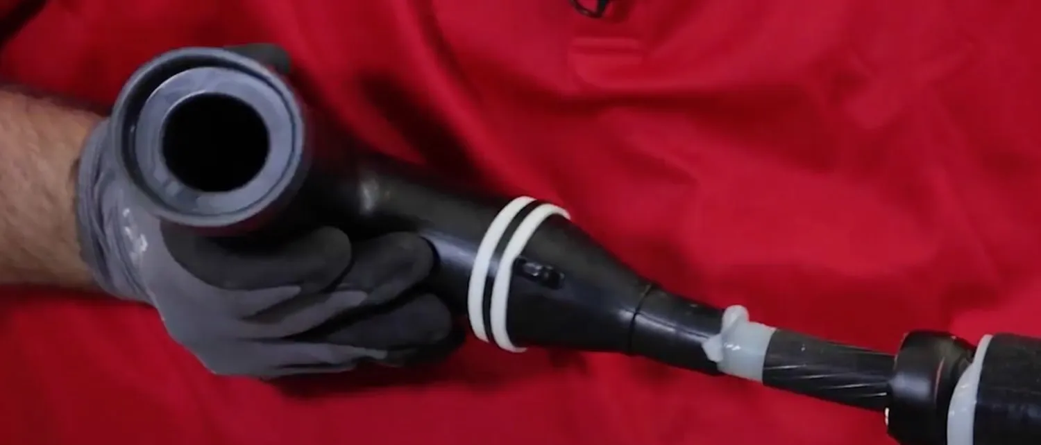 Technician fits elbow head onto the cable