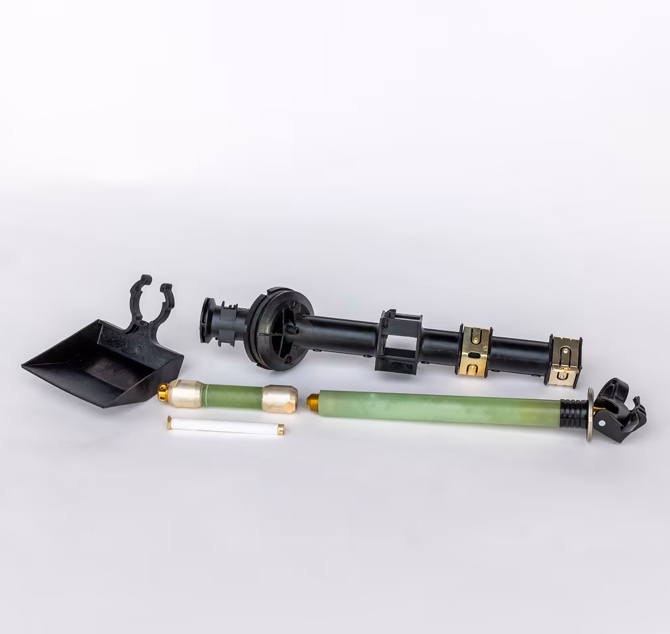 Various electrical and mechanical parts including a black plastic scoop and green cylindrical components.