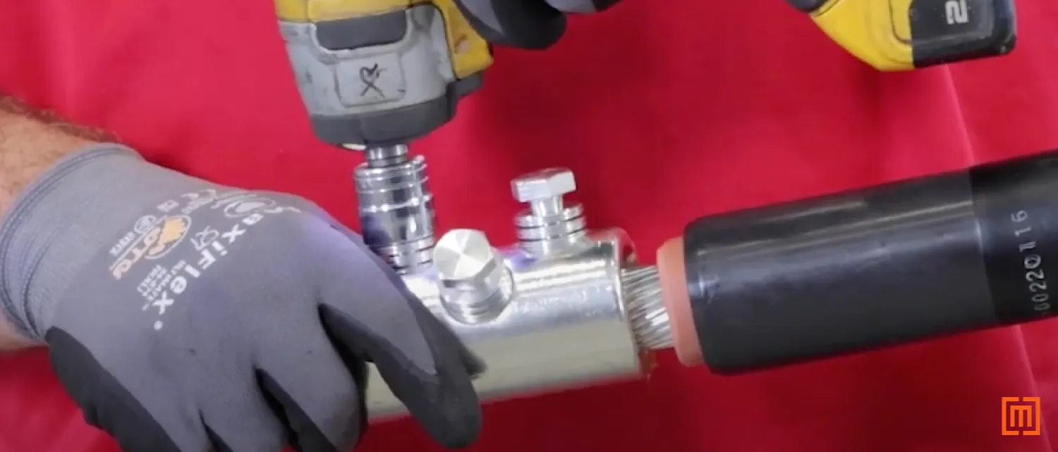 Technician tightening shear bolts on lug