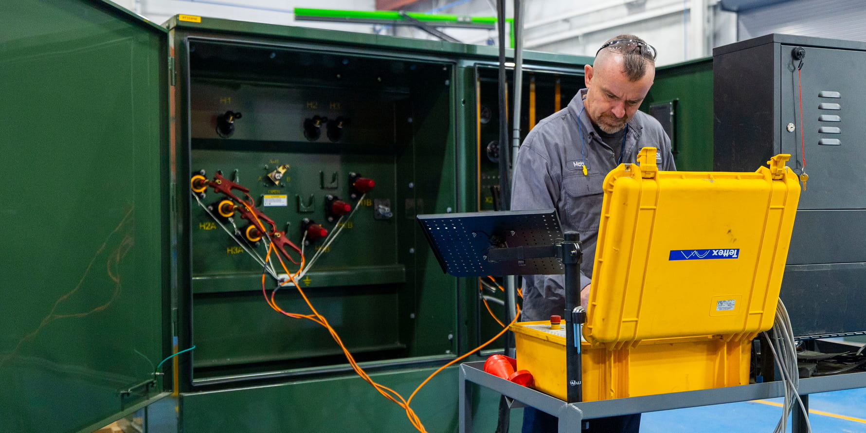 Green liquid filled padmounted transformer roped off for testing