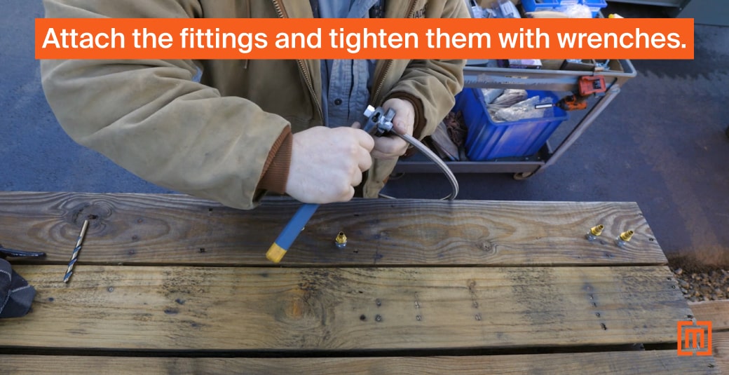 Mechanic tightening fittings on transformer sample hose