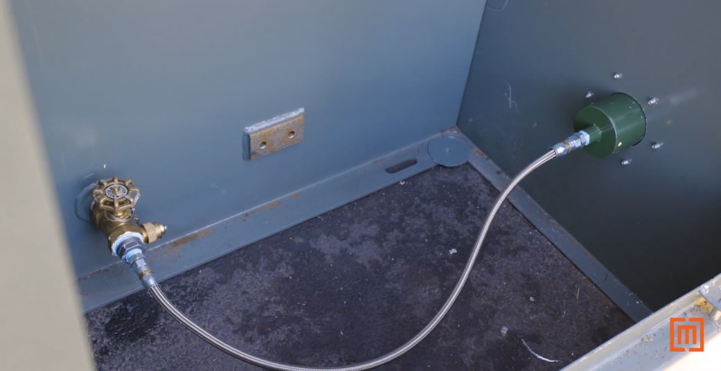 Oil sample hose in padmount transformer cabinet interior