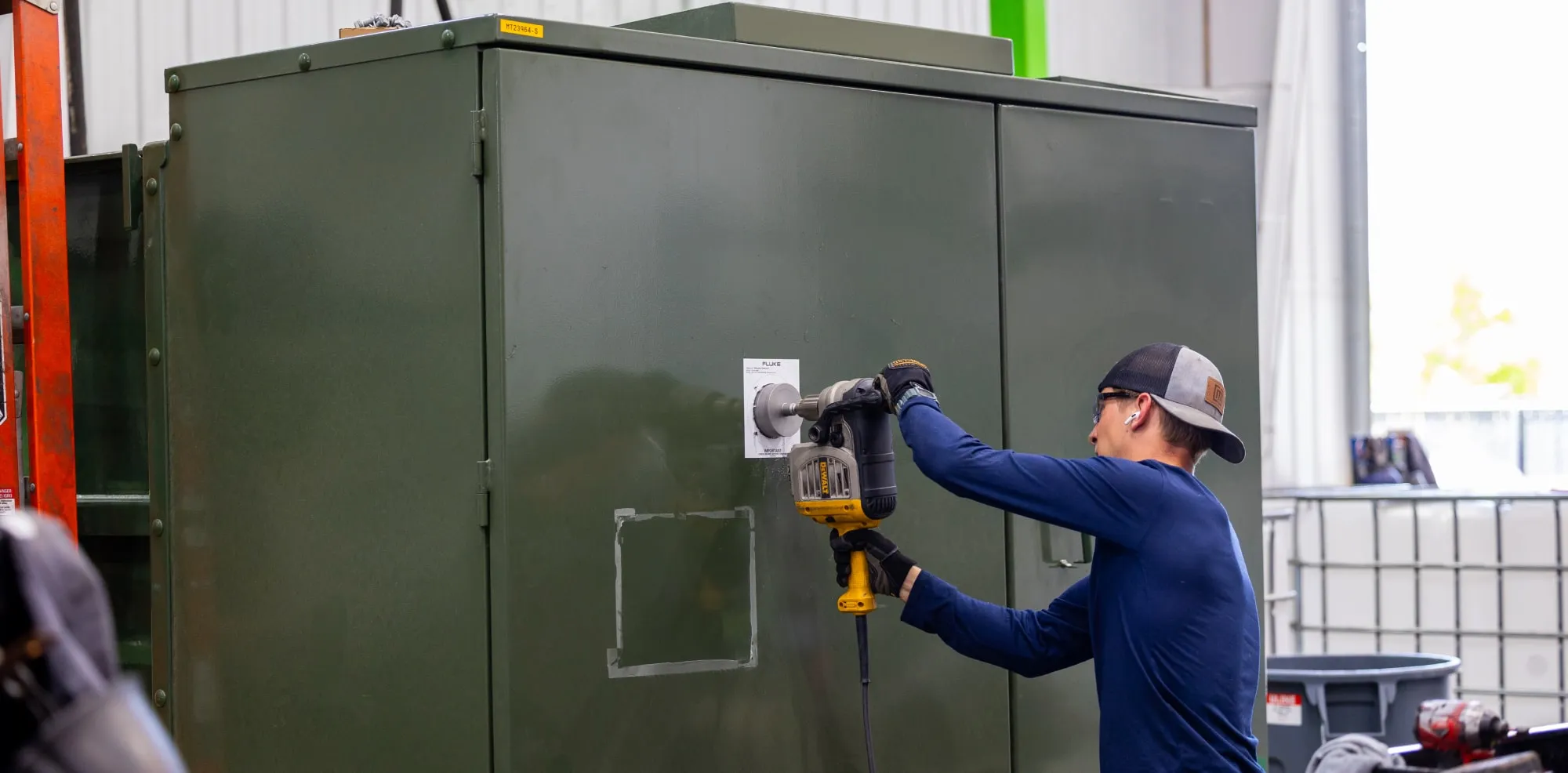 Maddox shop employee installing IR window on padmount