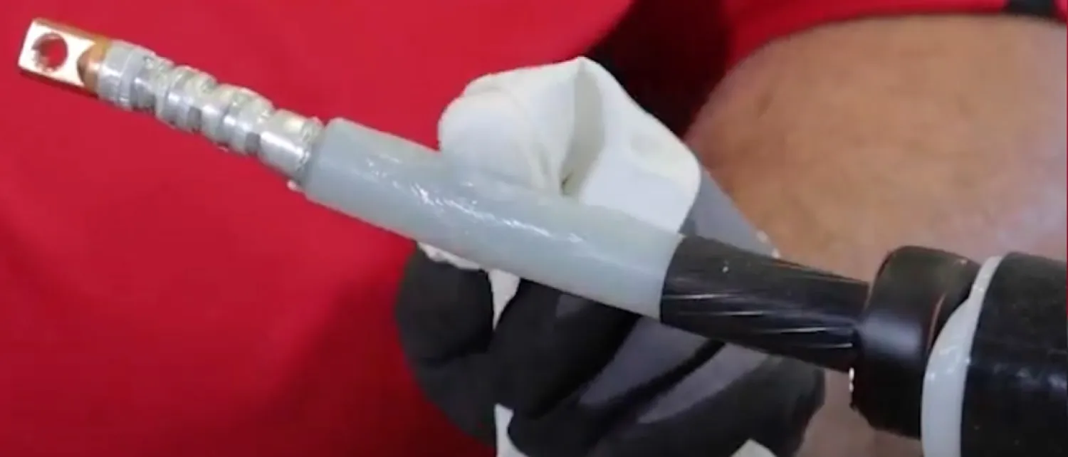 Technician rubs supplied silicone sealant on the cables insulation