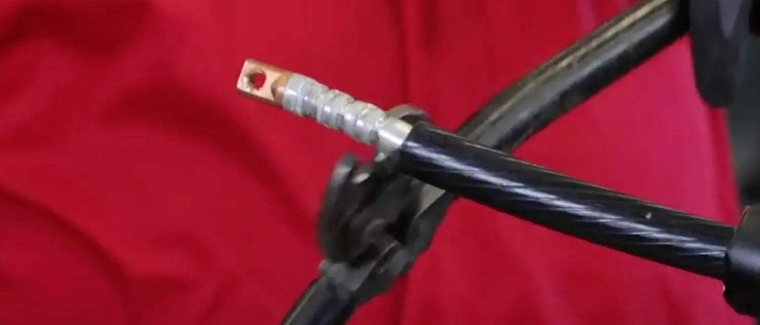 Technician crimping connector on the end of the cable