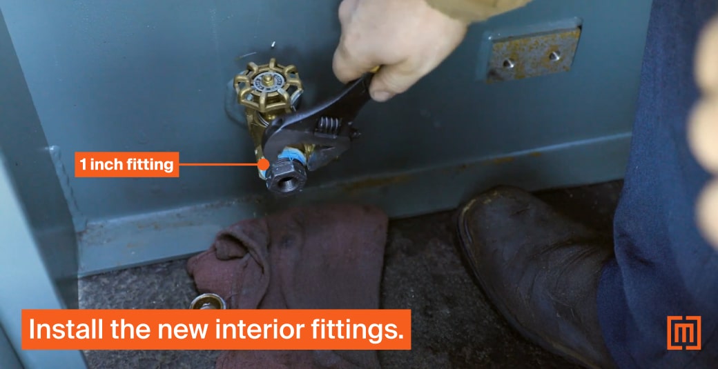 Mechanic tightening interior transformer cabinet fittings with wrench