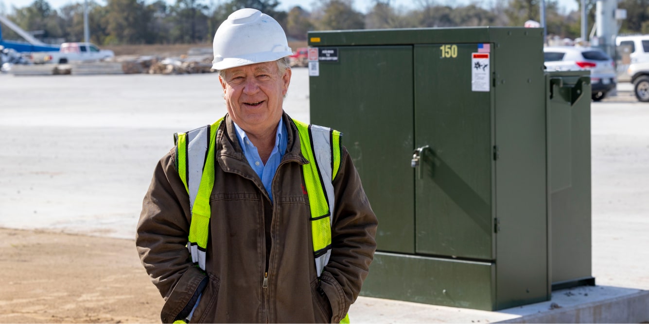 Maddox customer infront of a 150 kVA padmount transformer