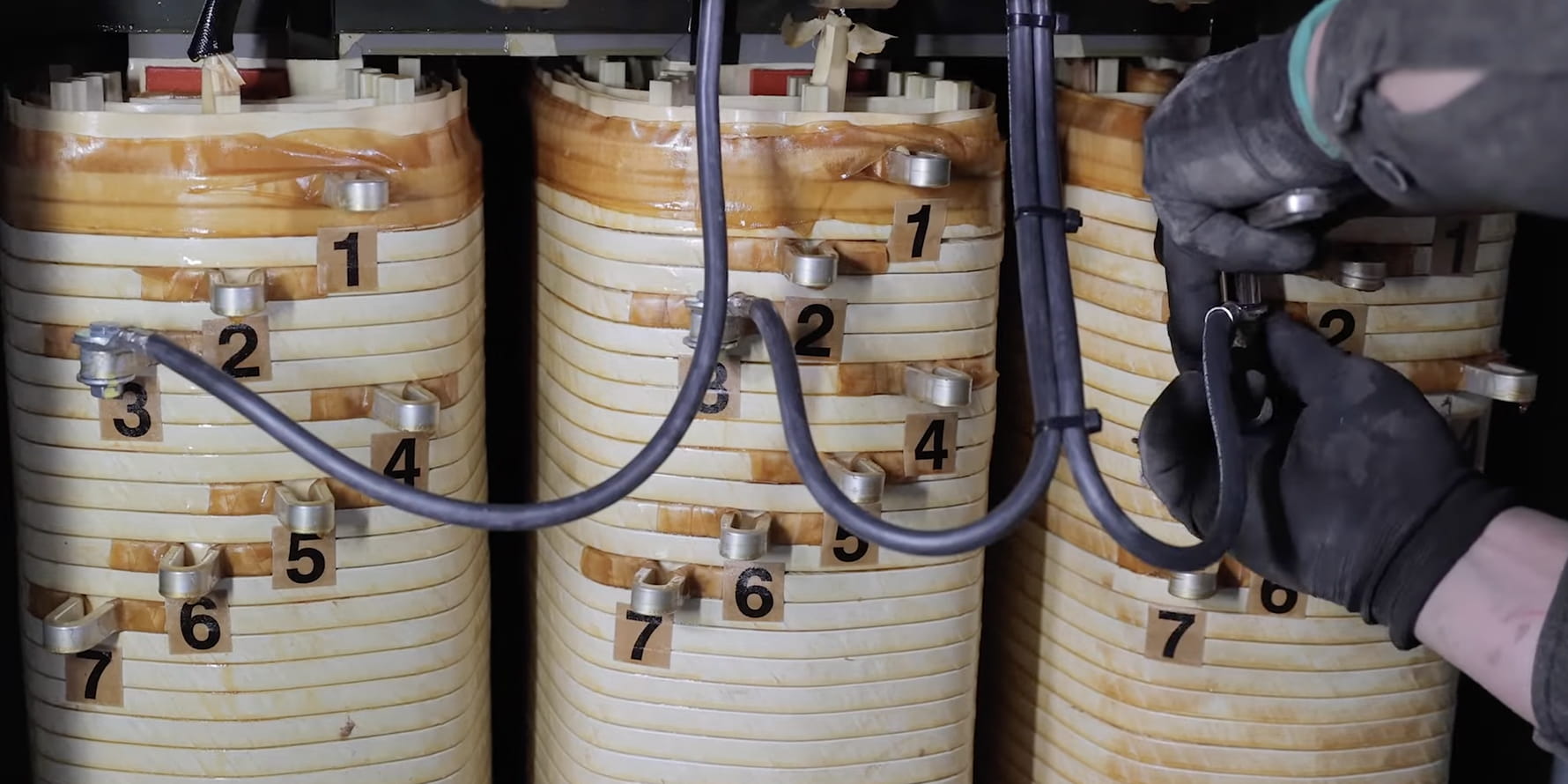 technician handling tap changers on a low voltage dry type transformer