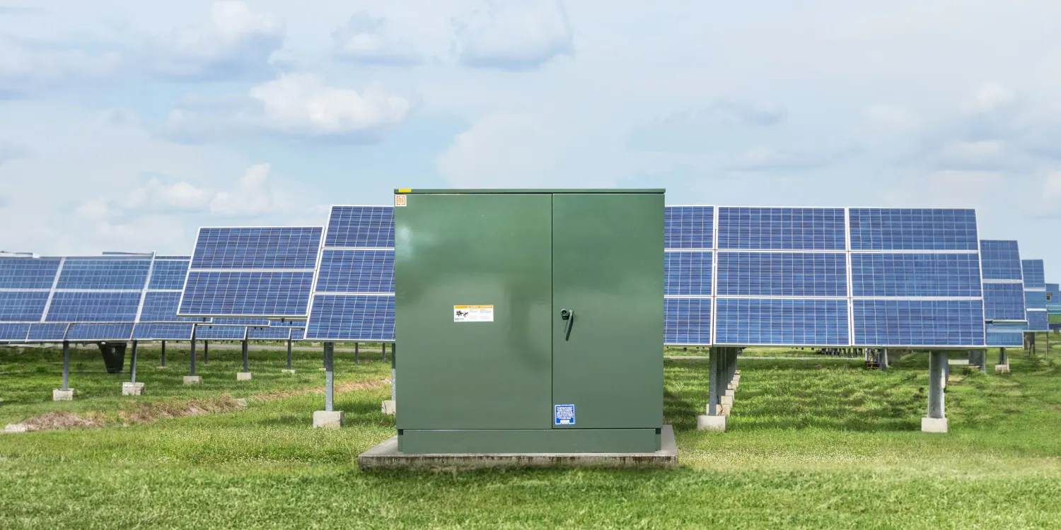 A Maddox padmount transformer infront of a solar array