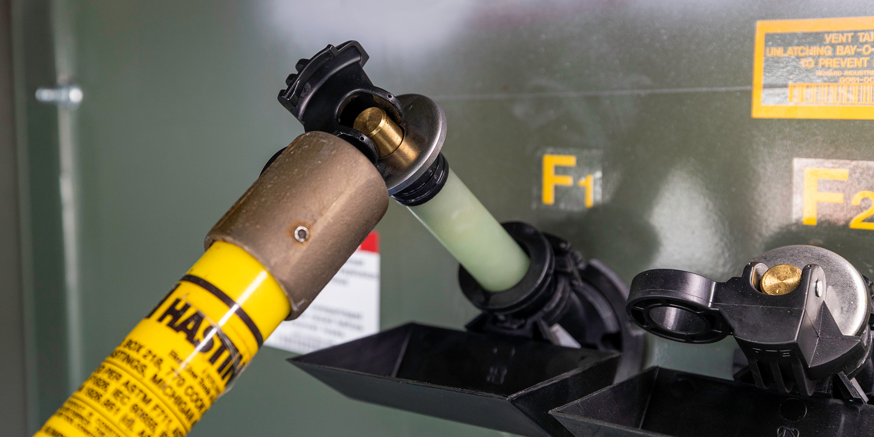 close up of removing bayonet fuse from padmount transformer using hot stick