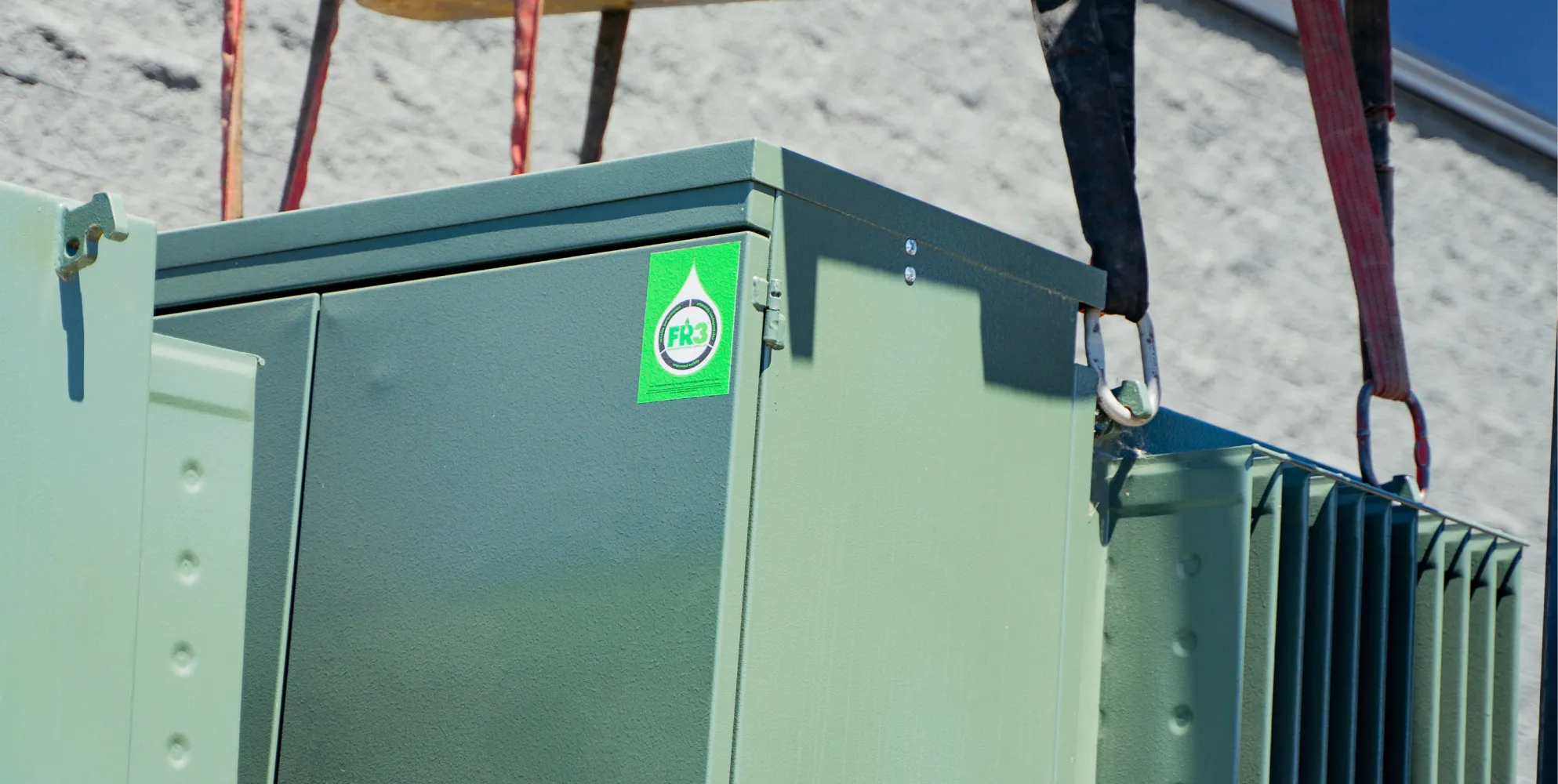 A padmount transformer filled with FR3® Fluid being loaded on a truck