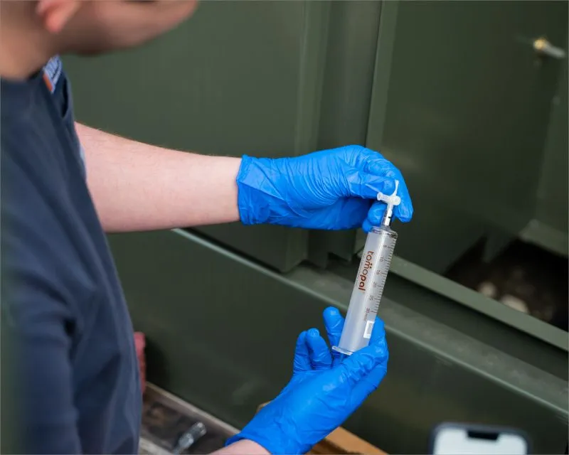Taking an oil sample from a liquid-filled transformer